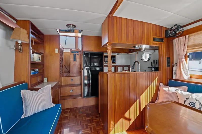 Slide: The Image of Interior of 1999 Kadey-Krogen 39 yacht with wood paneling and cozy seating area. - 4