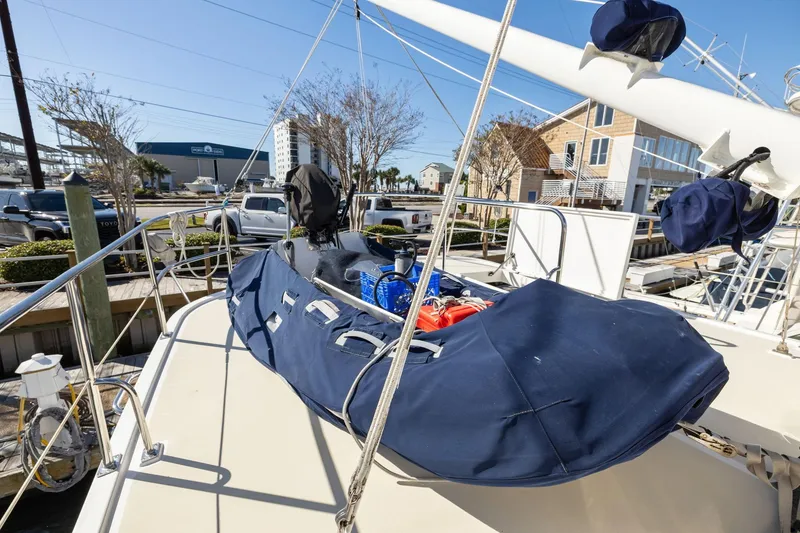 Slide: The Image of 1999 Kadey-Krogen 39 yacht deck with covered equipment and marina view. - 45