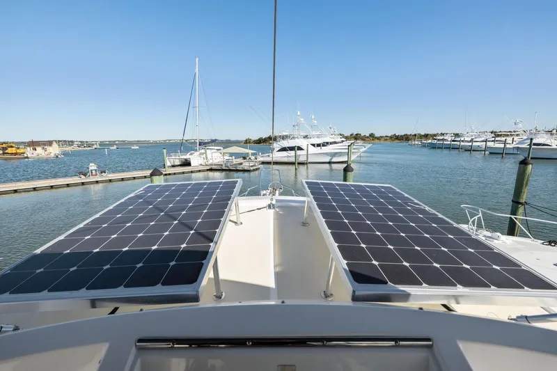 Slide: The Image of 1999 Kadey-Krogen 39 yacht with solar panels docked in a marina. - 46