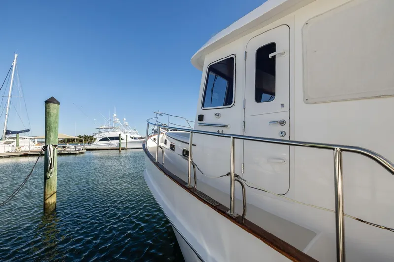 Slide: The Image of 1999 Kadey-Krogen 39 yacht docked at marina under clear blue sky. - 47