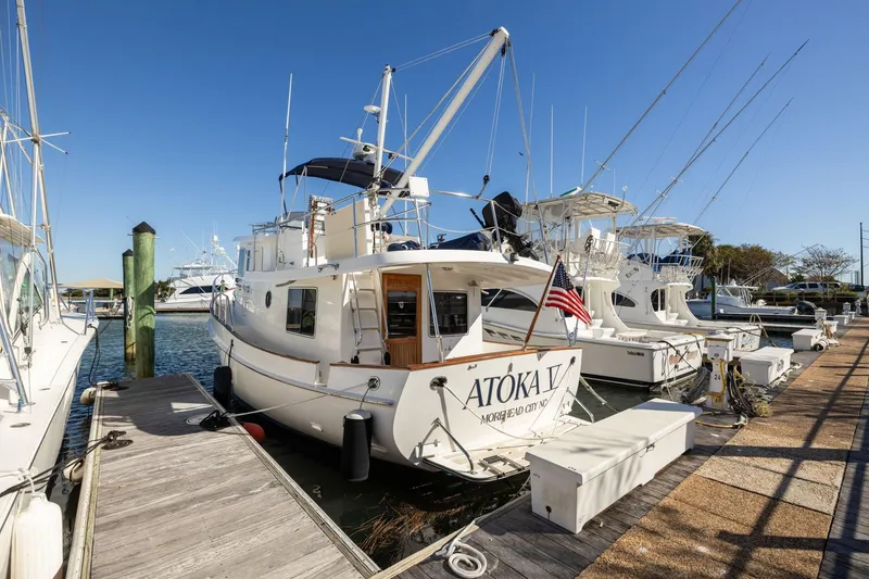 Slide: The Image of 1999 Kadey-Krogen 39 yacht docked at marina under clear blue sky. - 48