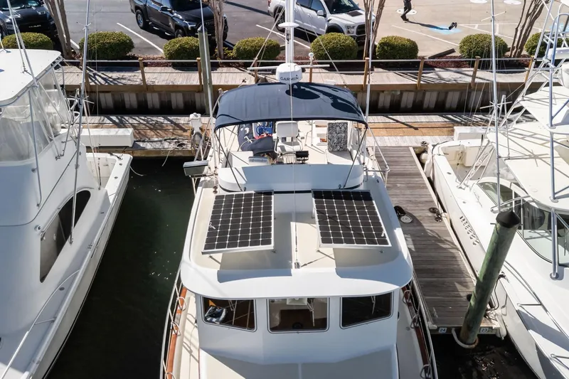 Slide: The Image of Kadey-Krogen 39 yacht from 1999 docked, featuring solar panels on the roof. - 53