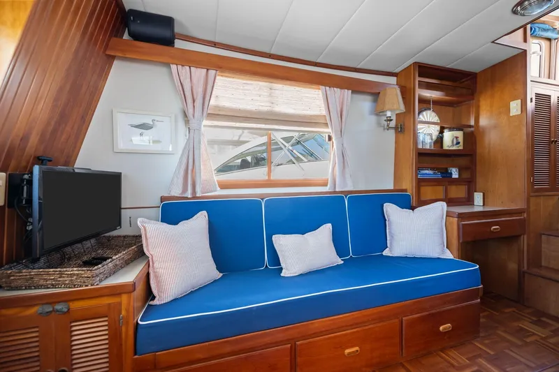 Slide: The Image of Cozy interior of 1999 Kadey-Krogen 39 yacht with blue seating and wooden accents. - 7
