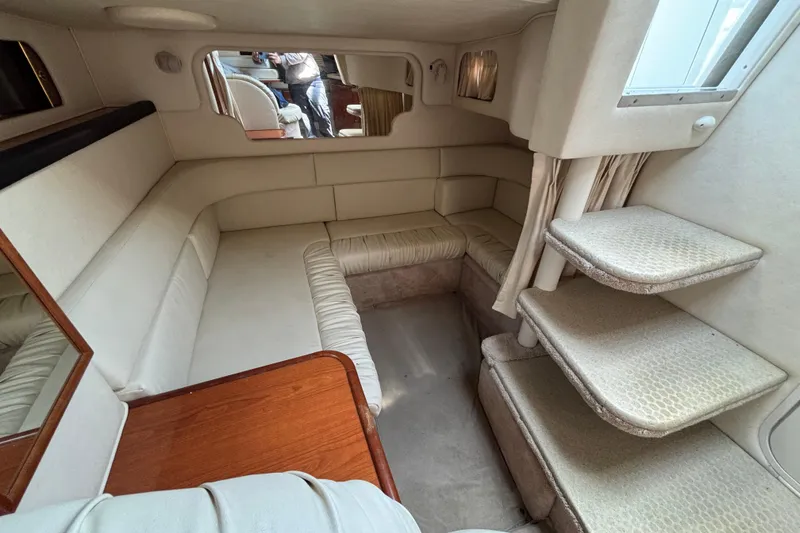Slide: The Image of Interior of a 2000 Sea Ray 340 Sundancer yacht, featuring cozy seating and elegant design. - 10