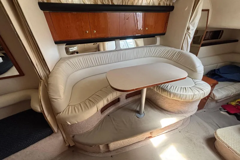 Slide: The Image of Interior of 2000 Sea Ray 340 Sundancer with curved seating and table. - 11