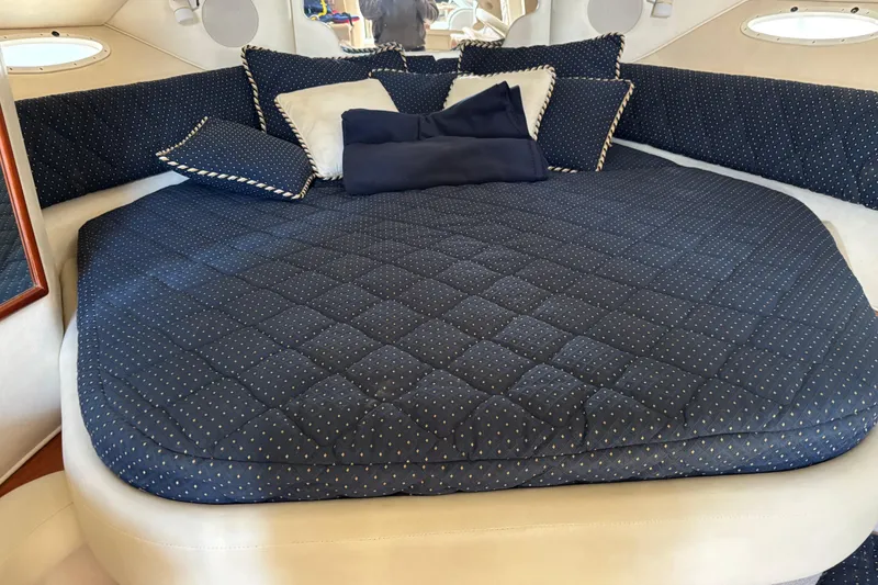 Slide: The Image of Luxurious cabin interior of 2000 Sea Ray 340 Sundancer with plush bedding. - 13