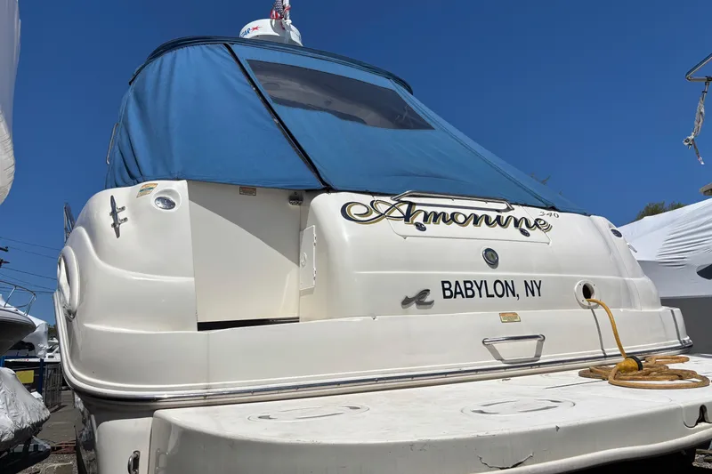 Slide: The Image of 2000 Sea Ray 340 Sundancer boat with blue cover, docked in Babylon, NY. - 3