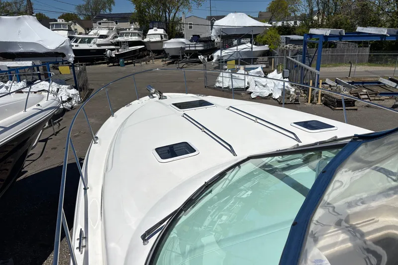 Slide: The Image of 2000 Sea Ray 340 Sundancer boat in a marina, surrounded by other vessels. - 4