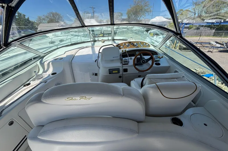 Slide: The Image of Cockpit of 2000 Sea Ray 340 Sundancer with white leather seating and wooden steering wheel. - 5