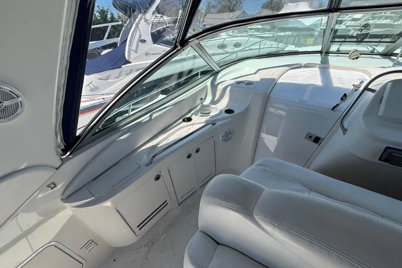 Slide: The Image of Interior view of a 2000 Sea Ray 340 Sundancer boat, showcasing sleek white seating and dashboard. - 6