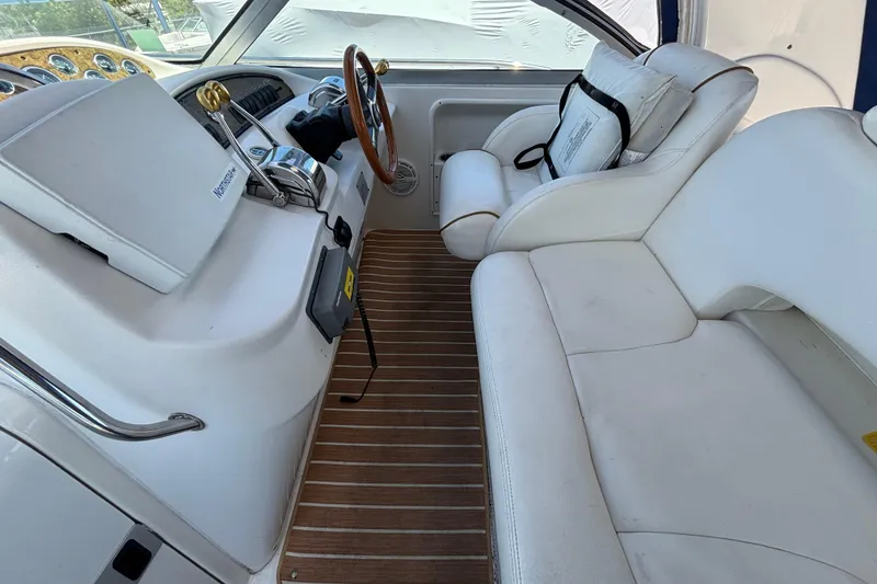 Slide: The Image of Interior of 2000 Sea Ray 340 Sundancer boat with white seating and wooden flooring. - 7