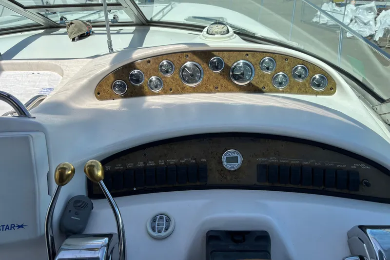 Slide: The Image of Control panel of a 2000 Sea Ray 340 Sundancer boat with gauges and switches. - 9