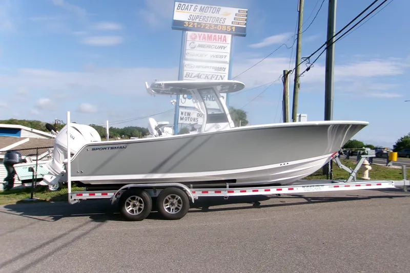 The Image of 2026 Sportsman Open 252 Center Console boat on trailer at dealership. - 1