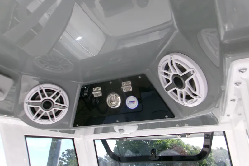 Slide: The Image of Interior view of 2026 Sportsman Open 252 Center Console with speakers and control panel. - 12