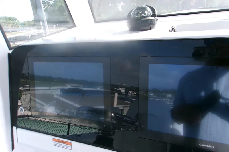 Slide: The Image of 2026 Sportsman Open 252 Center Console dashboard with dual Garmin displays and compass. - 14