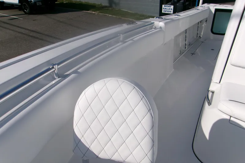 Slide: The Image of 2026 Sportsman Open 252 Center Console boat interior with white quilted seating. - 16