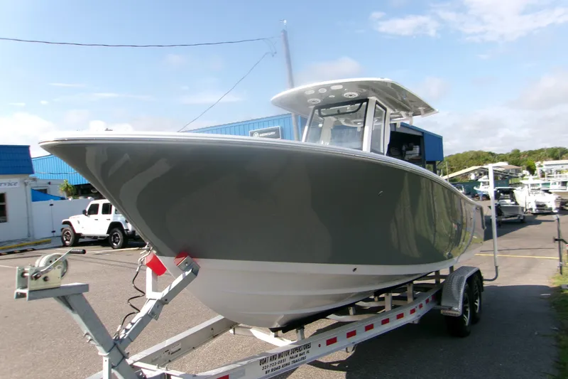 Slide: The Image of 2026 Sportsman Open 252 Center Console boat on trailer, parked outdoors. - 3