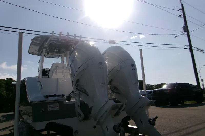 Slide: The Image of 2026 Sportsman Open 252 Center Console boat with dual outboard engines under bright sun. - 4
