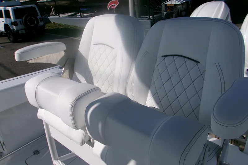 Slide: The Image of 2026 Sportsman Open 252 Center Console boat with luxurious white seating. - 7