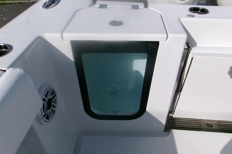Slide: The Image of 2026 Sportsman Open 252 Center Console boat interior detail with storage compartment. - 9