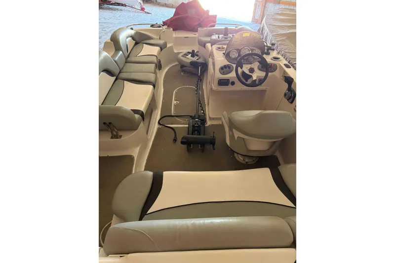 Slide: The Image of 2013 Starcraft 2000 IO Limited boat interior with seating and steering console. - 1