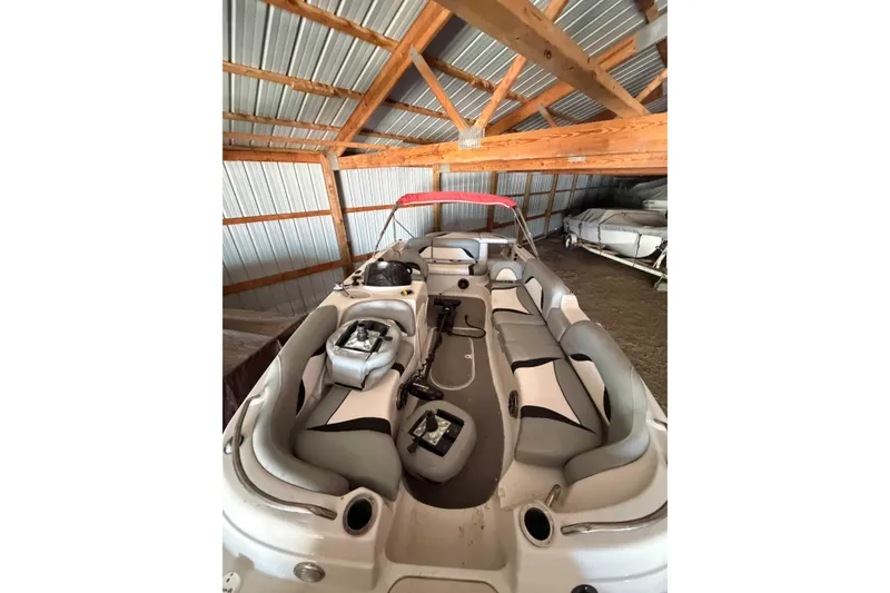 Slide: The Image of 2013 Starcraft 2000 IO Limited boat interior in a wooden storage shed. - 3