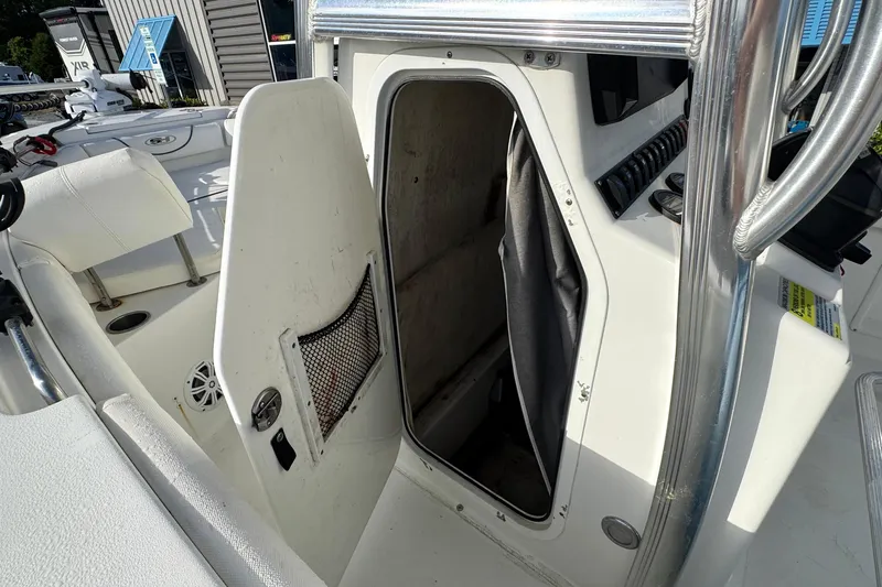 Slide: The Image of 2016 Sea Hunt Ultra 211 boat interior storage compartment with open door. - 10