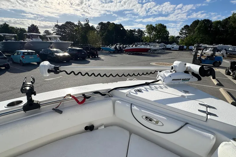 Slide: The Image of 2016 Sea Hunt Ultra 211 boat with Minn Kota trolling motor in a parking lot. - 12