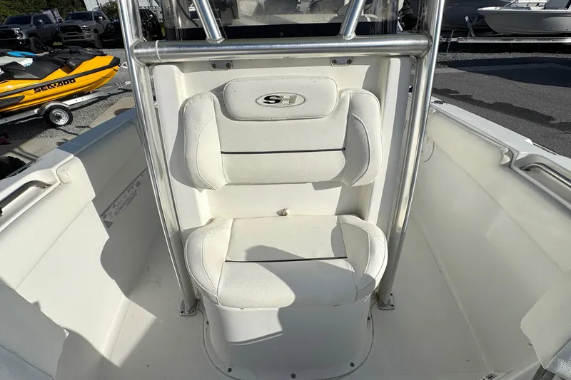 Slide: The Image of 2016 Sea Hunt Ultra 211 boat interior with white cushioned seating and stainless steel frame. - 14