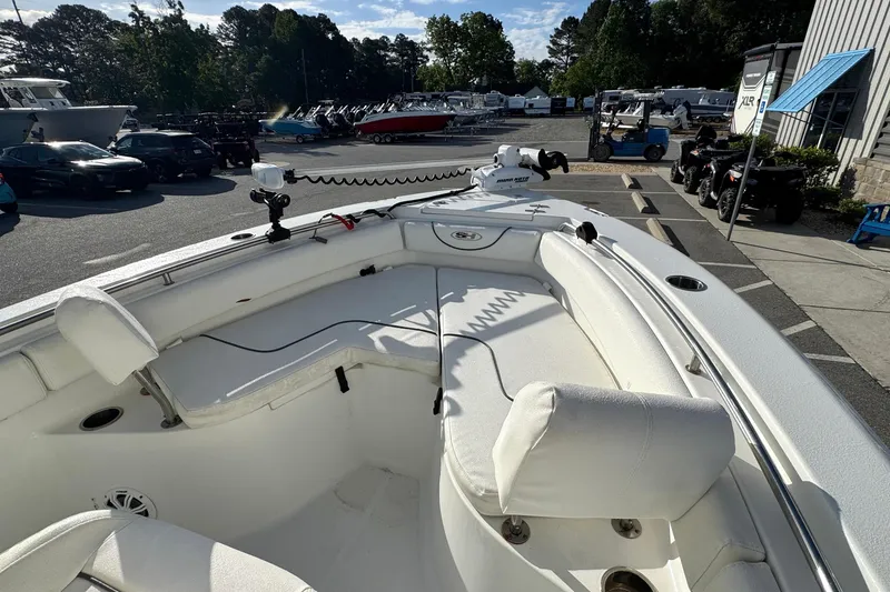 Slide: The Image of 2016 Sea Hunt Ultra 211 boat interior with seating and equipment, parked outdoors. - 15