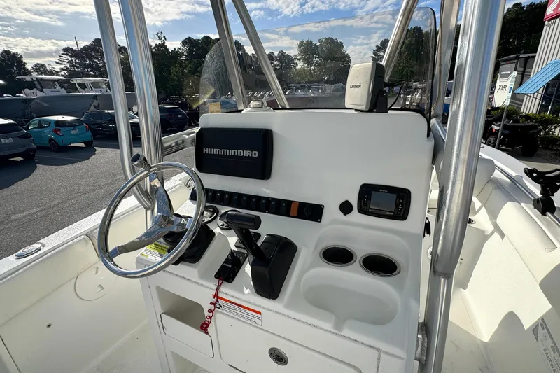 Slide: The Image of 2016 Sea Hunt Ultra 211 boat console with steering wheel and navigation equipment. - 16