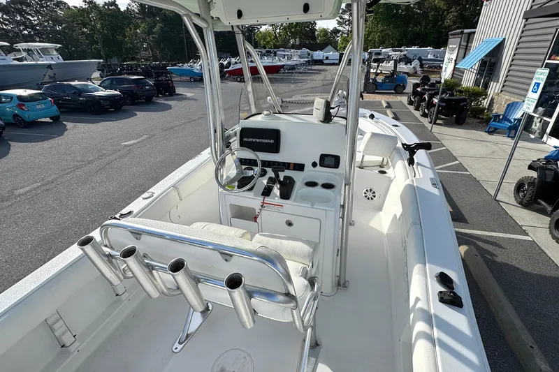Slide: The Image of 2016 Sea Hunt Ultra 211 boat interior with steering console and rod holders. - 17