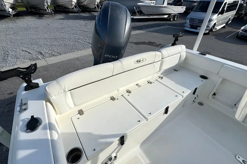 Slide: The Image of 2016 Sea Hunt Ultra 211 boat interior with Yamaha 200 engine, docked near other boats. - 18