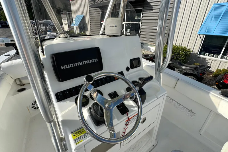 Slide: The Image of 2016 Sea Hunt Ultra 211 boat console with Humminbird electronics and steering wheel. - 9