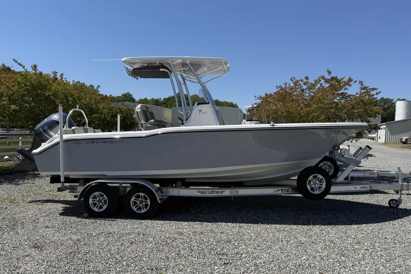 The Image of 2026 Key West 239 FS boat on trailer, parked outdoors under clear sky. - 0