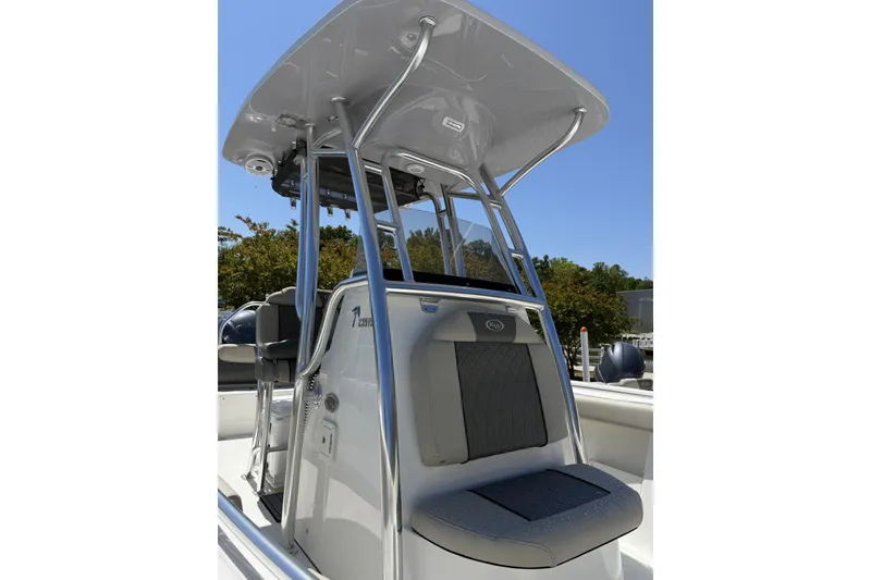 Slide: The Image of 2026 Key West 239 FS boat with T-top and seating, under clear blue sky. - 2