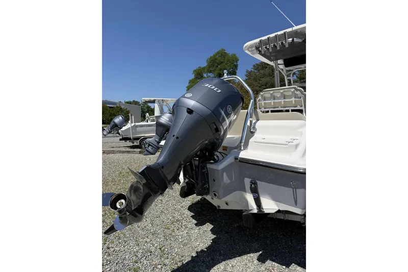 Slide: The Image of 2026 Key West 239 FS boat with powerful outboard motor, parked outdoors. - 6