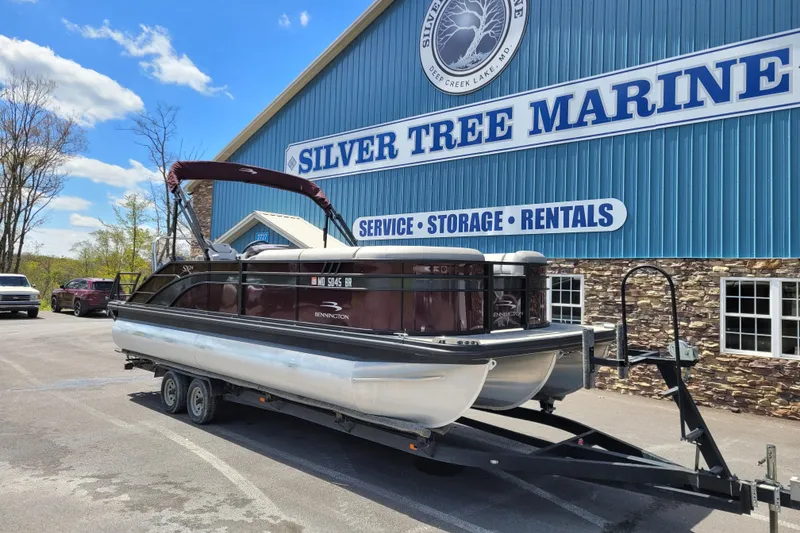 Slide: The Image of 2021 Bennington 24 SSBX pontoon boat on trailer at Silver Tree Marine. - 2