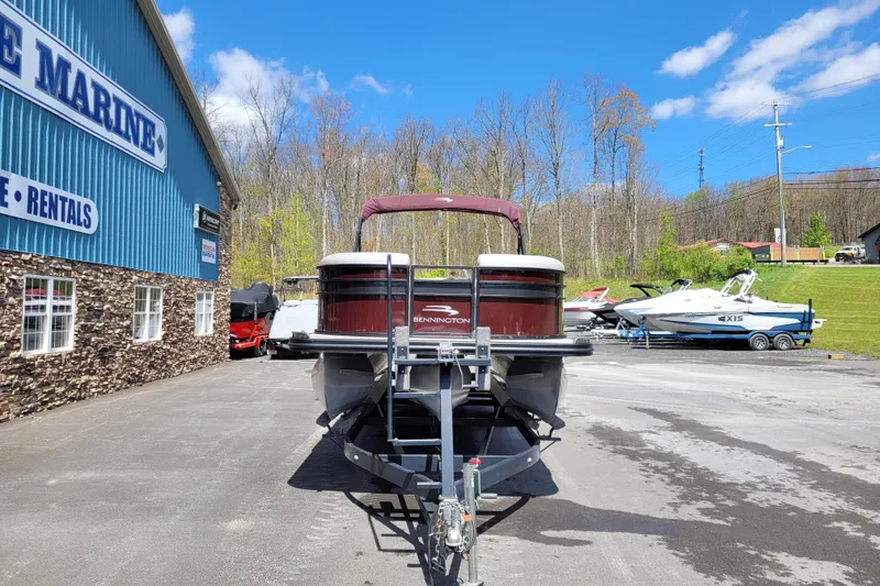 Slide: The Image of 2021 Bennington 24 SSBX pontoon boat parked outside a marine dealership. - 3