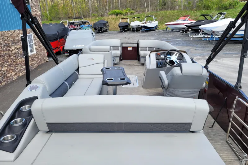 Slide: The Image of 2021 Bennington 24 SSBX pontoon boat interior with seating and steering console. - 7