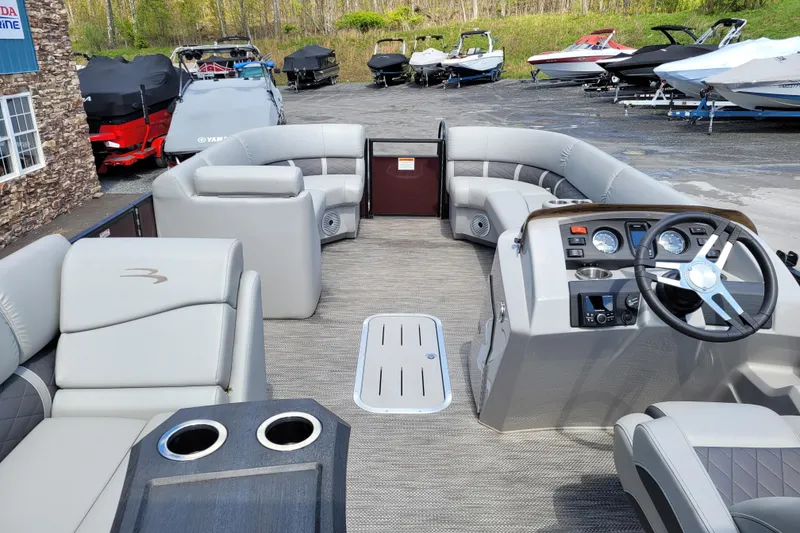 Slide: The Image of 2021 Bennington 24 SSBX pontoon boat interior with plush seating and modern dashboard. - 8