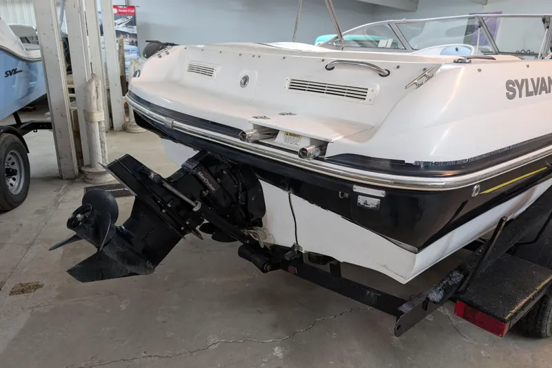 Slide: The Image of 2005 Sylvan V190 I/O boat rear view with outboard motor in a garage. - 3