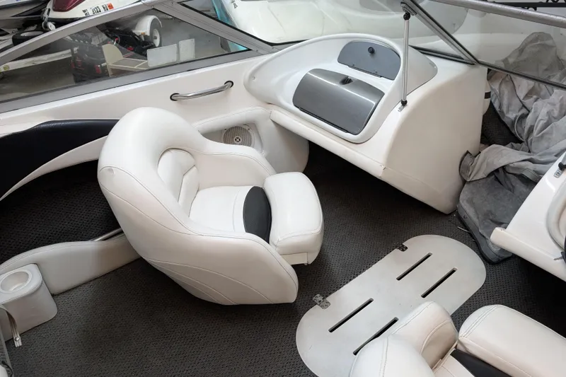 Slide: The Image of Interior of a 2005 Sylvan V190 I/O boat with white seating and dashboard. - 5