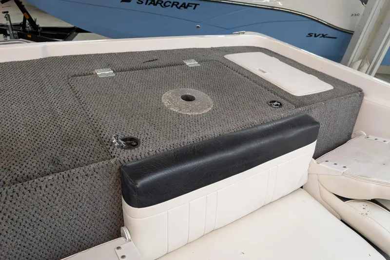 Slide: The Image of 2005 Sylvan V190 I/O boat interior with carpeted deck and seating. - 7