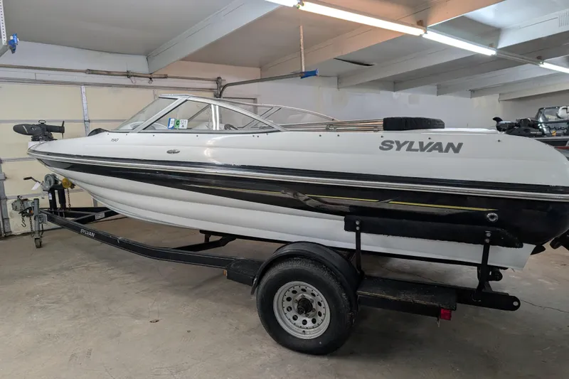 Slide: The Image of 2005 Sylvan V190 I/O boat on trailer in a garage setting. - 8