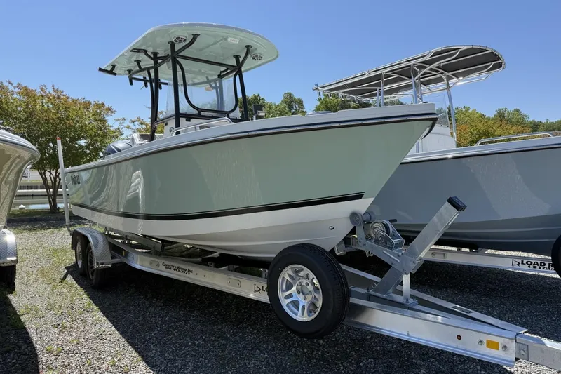 The Image of 2026 Parker 230 Coastal Elite boat on trailer, displayed outdoors under clear sky. - 1