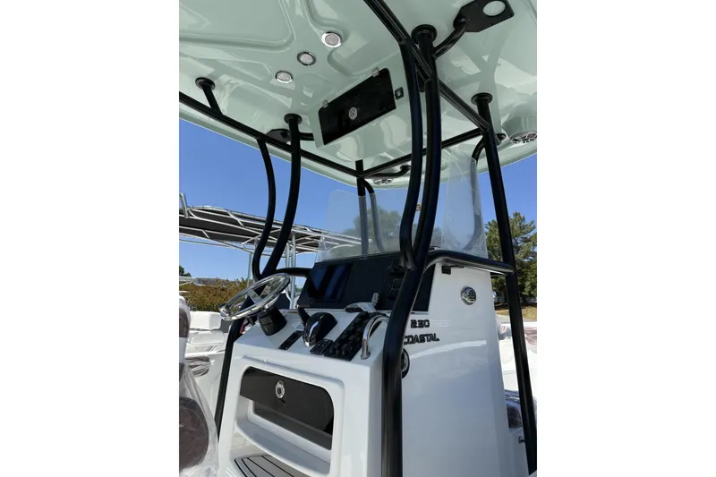 Slide: The Image of 2026 Parker 230 Coastal Elite boat console with steering wheel and controls. - 3