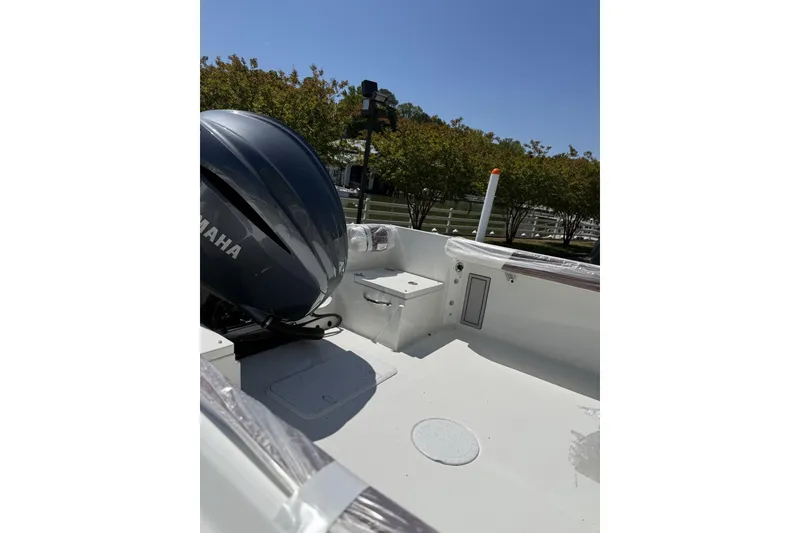 Slide: The Image of 2026 Parker 230 Coastal Elite boat interior with Yamaha engine, sunny day. - 4