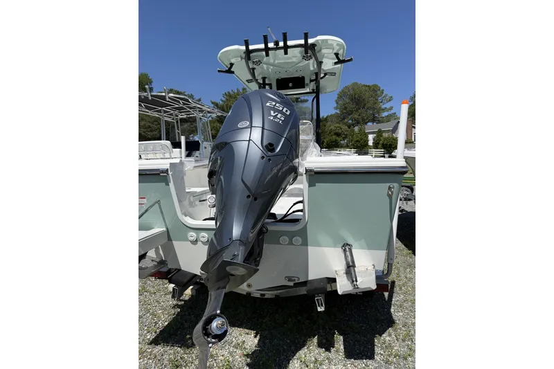 Slide: The Image of 2026 Parker 230 Coastal Elite boat with powerful outboard motor, parked outdoors. - 5