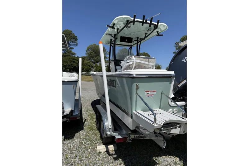 Slide: The Image of 2026 Parker 230 Coastal Elite boat on trailer, rear view, outdoors. - 7